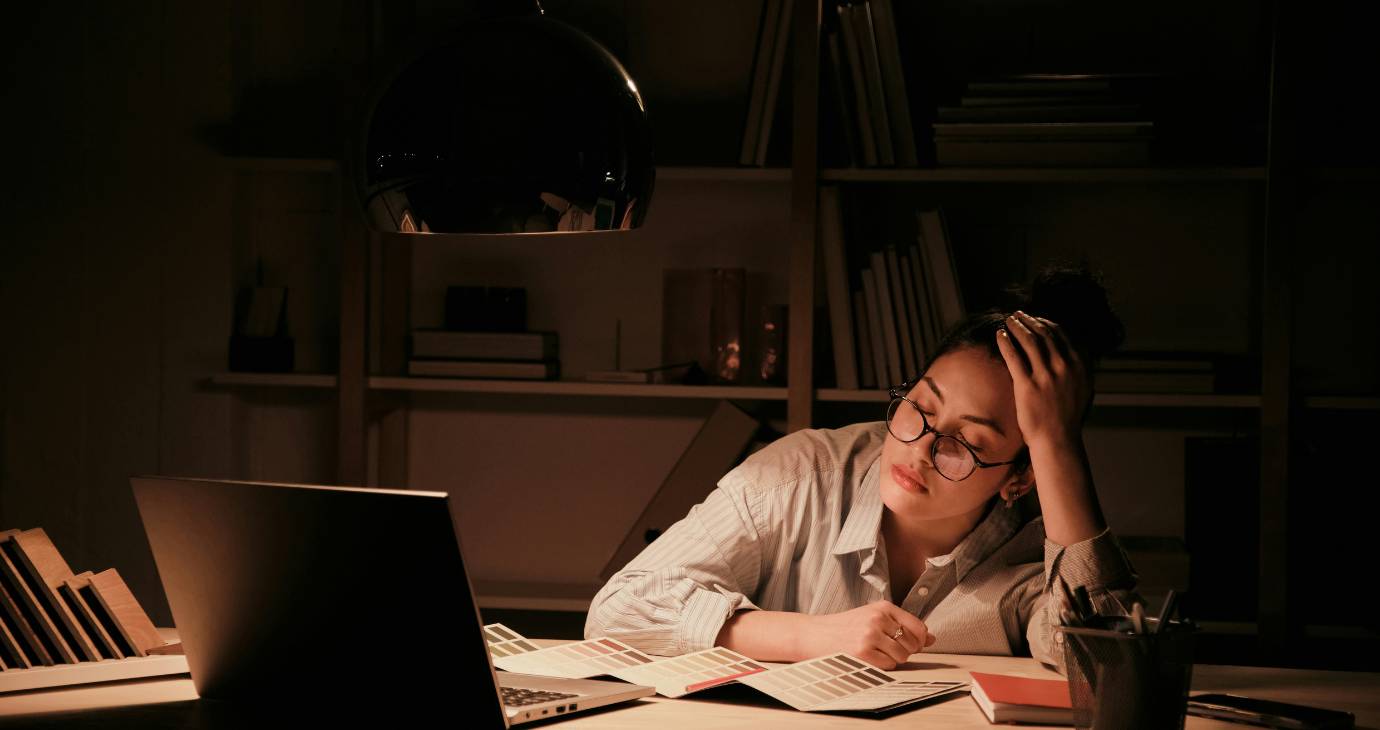 Woman at desk experiencing burnout