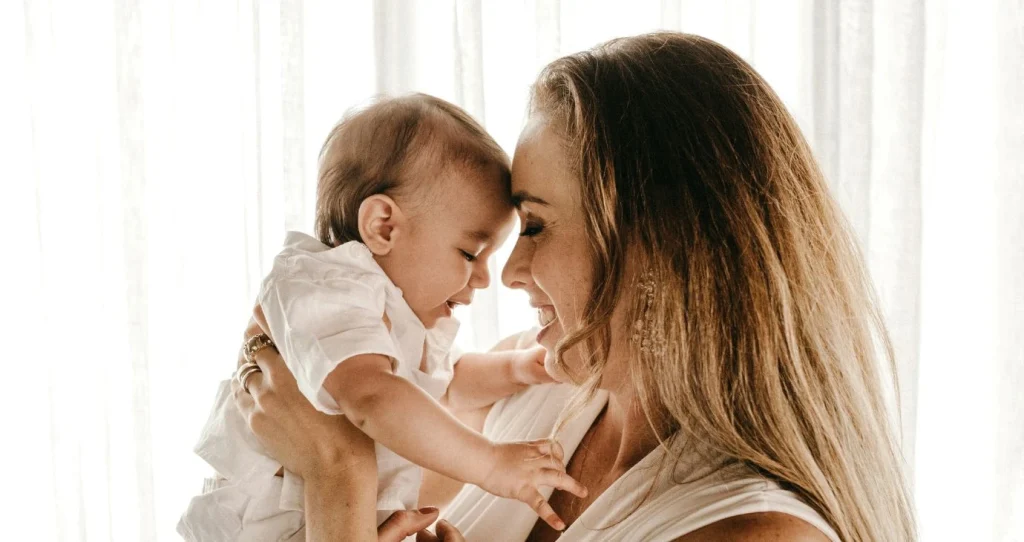 Image of mother holding baby against her head.